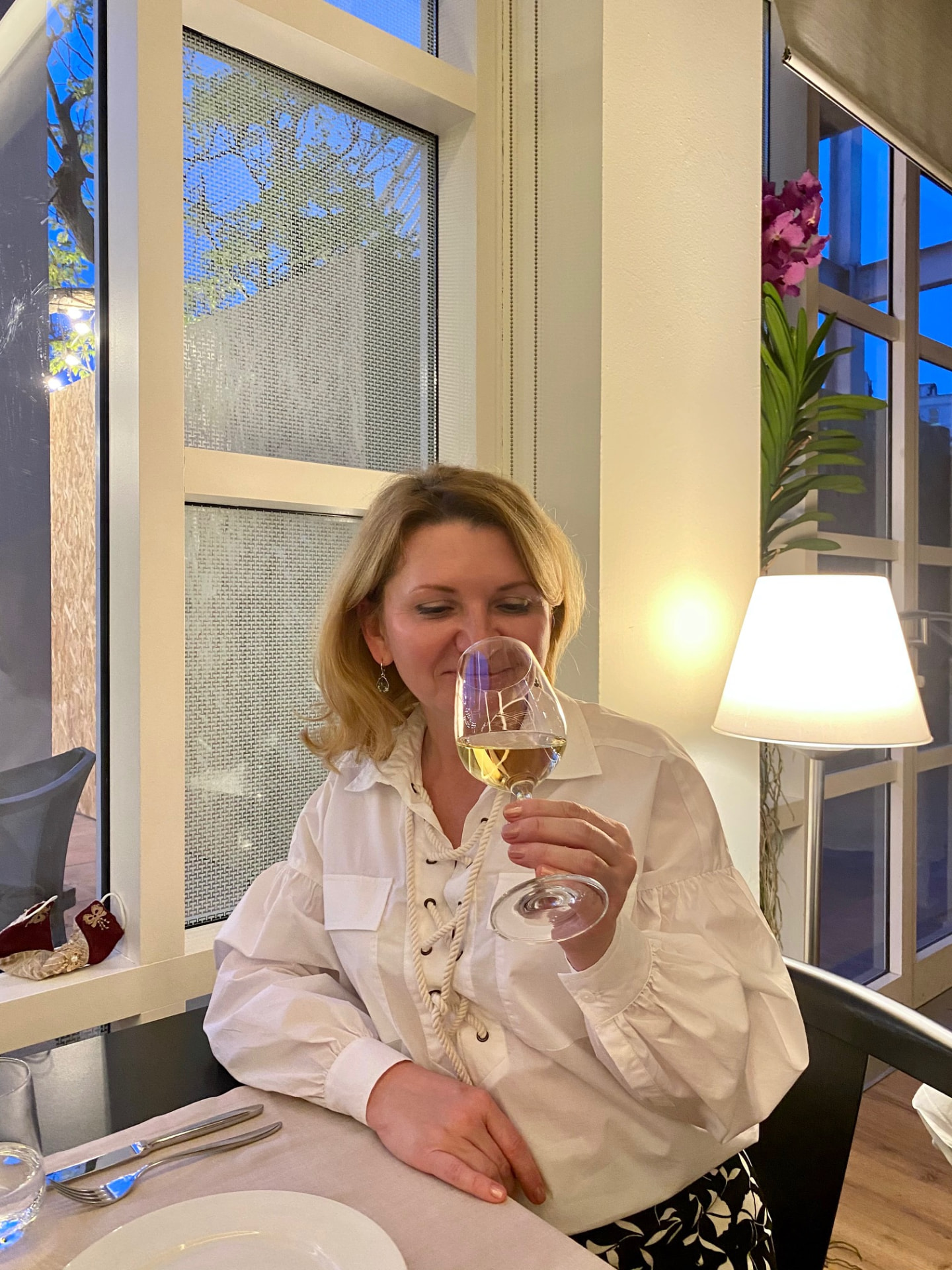 Alexandra Kalinina, WSET Level 3 certified Cava expert and private wine guide, tasting wine at a Catalan restaurant