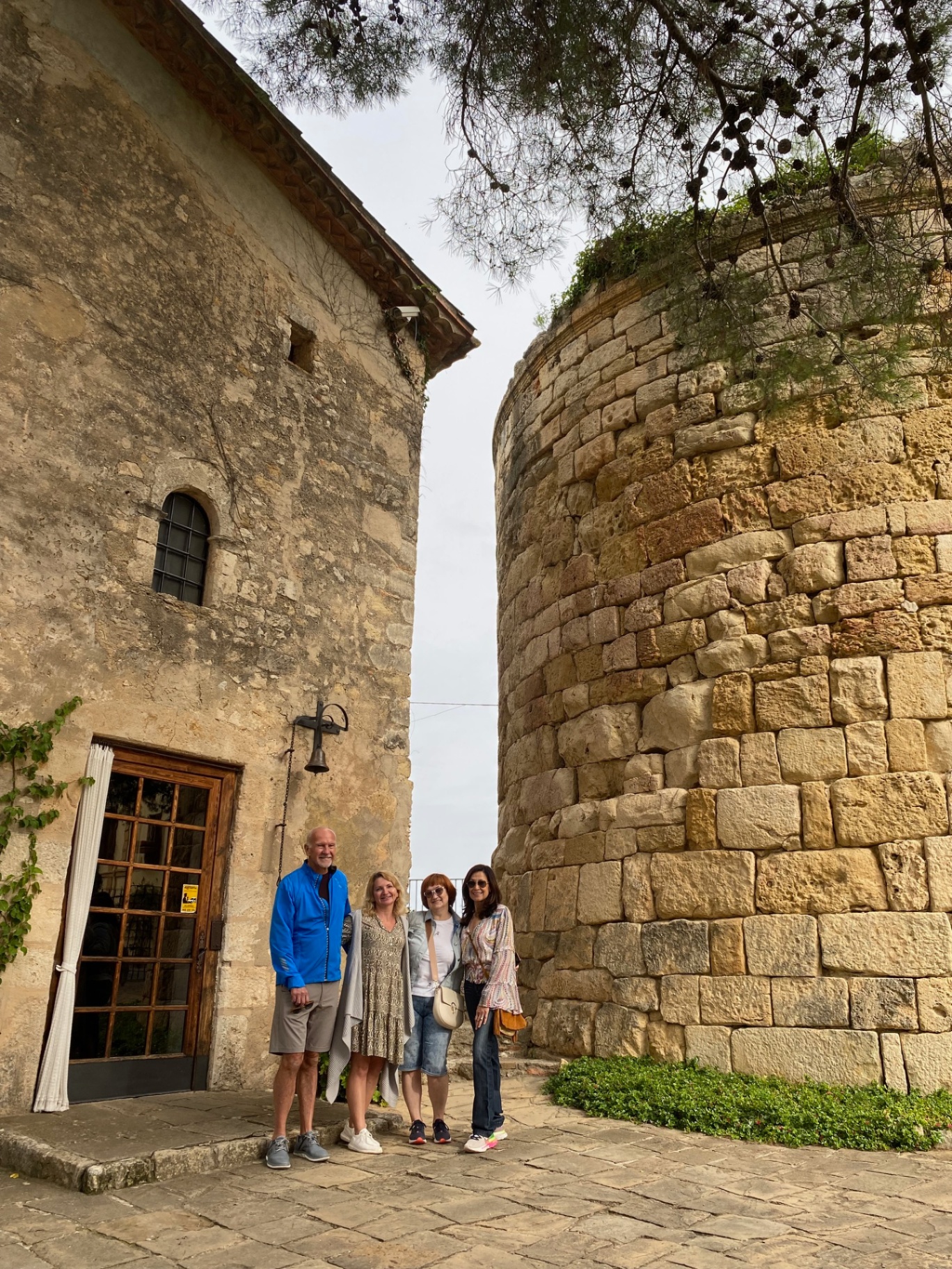 Group at a historic Romanesque stone church and tower